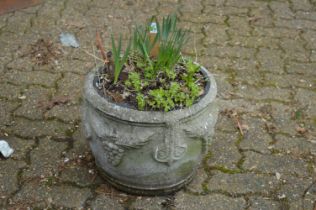 A pair of reconstituted stone planters.