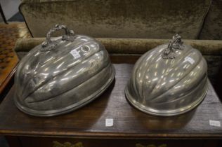 Two melon shaped metal meat domes.