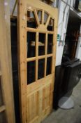 A pine door, the upper section for glazing.