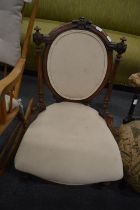 A Victorian walnut and upholstered occasional chair.