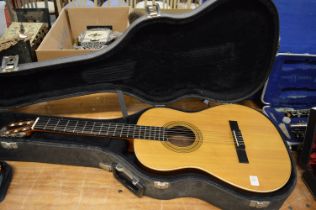 A classical guitar with hard case.