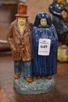 Gilbert Monteyne, a pottery figure group depicting a man and woman.