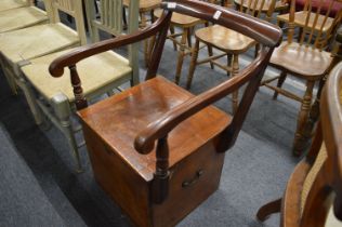 A mahogany commode chair.