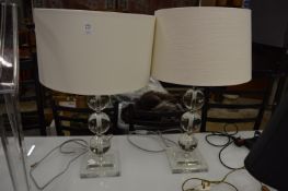 A pair of large glass table lamps.