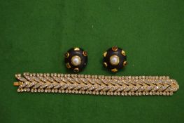 Decorative gilt metal bracelet, signed and a pair of stylish ear clips.