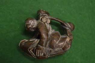 A carved wood netsuke.