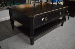 An ebonised two-tier two drawer coffee table.