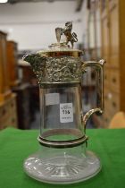 A good cut glass claret jug with plated mounts, the hinged cover with lion rampant and shield