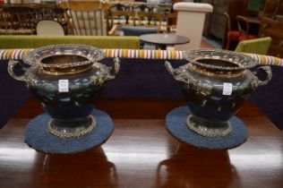 A good pair of plated twin handle urn shaped wine coolers with separate liners.
