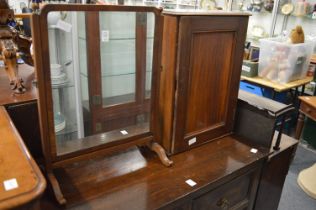 A mahogany dressing table mirror and a small hanging cupboard.