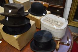 A top hat with original box together with a boxed bowler hat and three other hats, top hat and