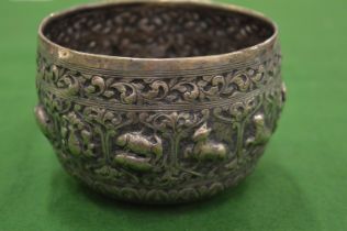 An Indian white metal bowl with embossed decoration.