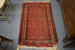 A small Persian Bokhara rug, 122cm x 81cm.