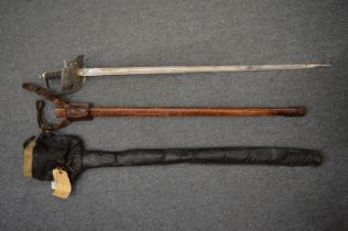 A George V dress sword with leather scabbard and outer cover.