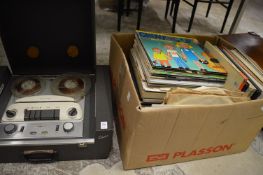 An old reel to reel tape player and a large box of records.