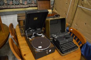 An HMV portable gramophone, gramophone records an old Royal typewriter and a Singer sewing machine.