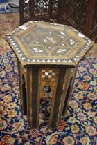 An Eastern mother of pearl inlaid octagonal occasional table.