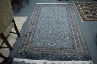 A Persian style Bokhara carpet, blue ground with three rows of ten gulls, 245cm x 155cm.