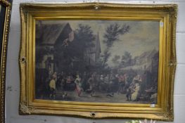 A large gilt framed colour print depicting figures merry making in a village setting.