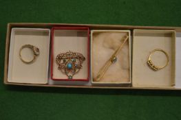 A gold and diamond ring, gold bar brooch, gold, turquoise and seed pearl brooch and another ring.