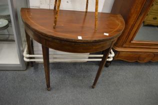 A 19th century mahogany D shaped fold-over tea table.