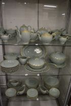A comprehensive Clarice Cliff dinner, tea and coffee service, green ground with gilt decorated