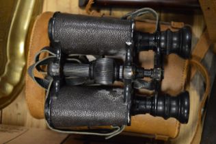 A leather cased pair of binoculars.