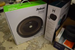 A robot vacuum cleaner, appears boxed and unused, together with other equipment.