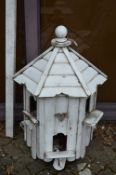 A large white painted wooden dovecote with post.