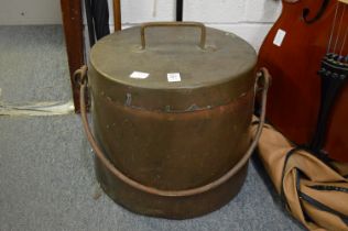 A large copper vessel with cover and wrought iron swing handle.