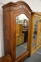 A 19th century French walnut dome top mirrored door single wardrobe with a drawer to the base.
