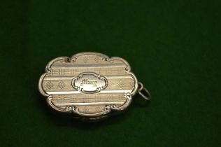 A small engraved silver vinaigrette.