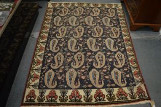 An unusual Persian design rug, dark blue ground with large stylised Boteh design, 195cm x 145cm.