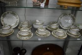 A comprehensive Continental porcelain tea service decorated with bands of flowers.