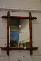 A small faux bamboo framed mirror.