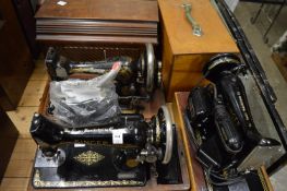 Three old Singer sewing machines.