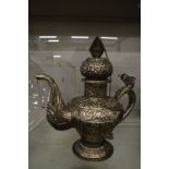 A large Eastern white metal ewer with embossed decoration.