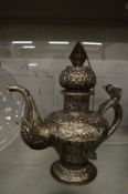 A large Eastern white metal ewer with embossed decoration.