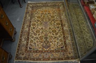 A good small Persian part silk rug, beige ground decorated with animals, birds and stylised flowers,