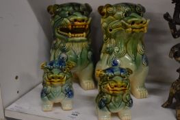 Two pairs of Chinese green glazed pottery lion dogs.