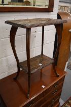 A carved wood two-tier occasional table.