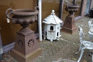 A good large pair of Victorian design cast iron twin handled urns on tapering bases.