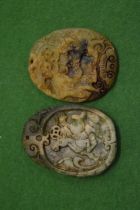 Two Chinese carved hard stone pendants.