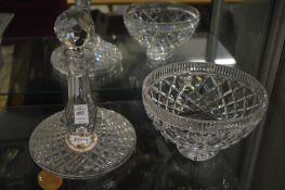 A cut glass port decanter with porcelain label and a cut glass bowl.