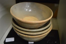 Four small earthenware bowls.