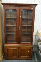 A small Victorian mahogany cupboard bookcase.