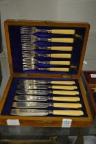 An oak cased set of six fish knives and forks.