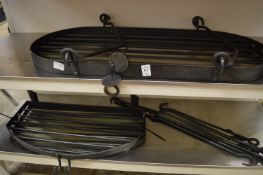 Three wrought iron kitchen hanging shelves with hooks.