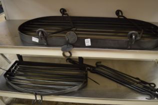 Three wrought iron kitchen hanging shelves with hooks.