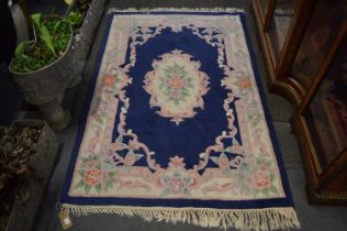 A Chinese rug, blue ground with floral decoration, 131cm x 129cm.